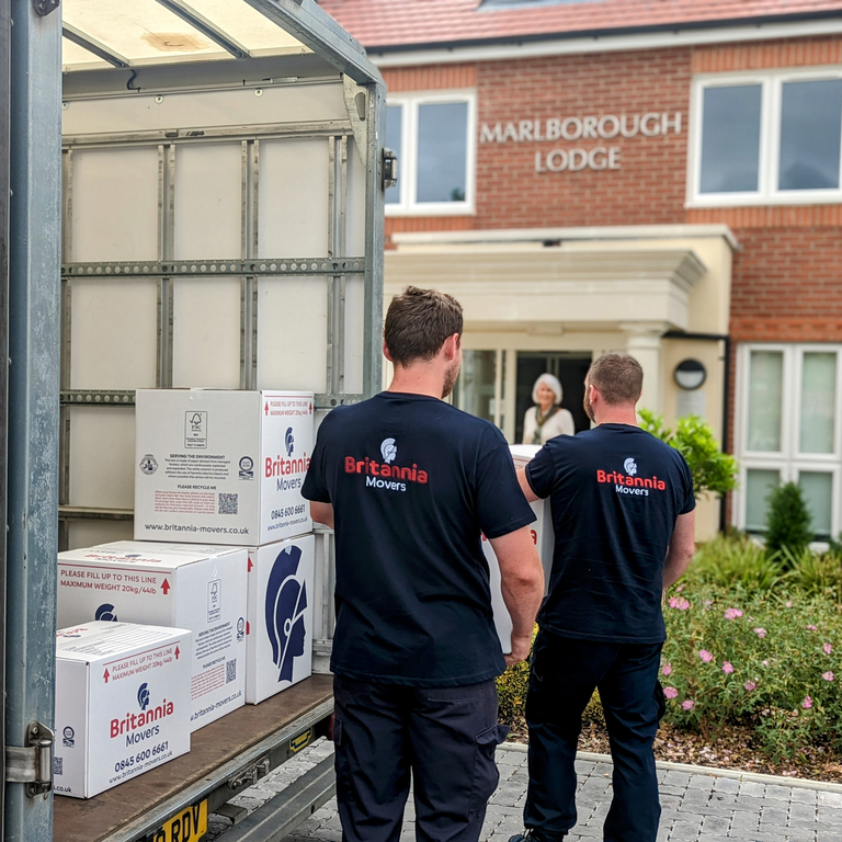 Team of Goodwins movers carefully loading furniture into a van at a Staffordshire property.